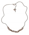 Every look could use a little bling. Fossil's sparkling fireball necklace features round-cut crystals in blush-tone hues. Setting and chain crafted in vintage brown tone mixed metal. Approximate length: 18 inches + 2-inch extender.