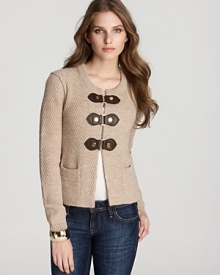 Combining preppy charm with urban edge, this Tory Burch cardigan flaunts a classic silhouette punctuated by oversized leather clasps for a masterfully mixed look. Keep the style strong with gleaming gold accents.