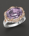 Diamonds, set in sterling silver and 18K. pink gold, frame a faceted east/west rose amethyst. By Tacori.