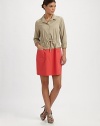 A fashion hybrid featuring the tailoring of a button-down and the flair of a classic dress. Collar neckButton frontDrawstring waistWaist dartsZipper detail on front pocketsAbout 33 from shoulder to hem67% cotton/28% polyester/5% elastaneDry cleanImportedModel shown is 5'9½ (176cm) wearing US size 4. OUR FIT MODEL RECOMMENDS ordering true size. 