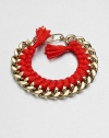 A chunky chain, with the look of a vintage ID bracelet, is modernized with bright red braiding with tassels and a fun paper-clip clasp.GoldplatedCottonLength, about 7.5Spring ring paper clip claspMade in France