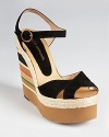 A colorful, striped wedge radiates summer style on Andre Assous' Pipoan wedges. These sky-high sandals bring the heat in soft black suede and braided jute trim.