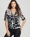 With a ribbon tie and a buckle at the neckline, this DIANE von FURSTENBERG stretch silk top is fashioned in a bold monochromatic print for a modern look to update your 7-day wardrobe.