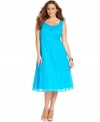 A slenderizing A-line shape elegantly defines J Jones New York's sleeveless plus size dress-- wear it from day to play!