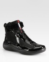 Shiny patent leather lace-ups with mesh details. Ankle tab closure Rubber sole Imported 