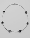 Six faceted discs of black onyx, dramatically stationed along a textured sterling silver chain. Black onyx Sterling silver Length, about 17 Heart-shaped lobster clasp Made in USA