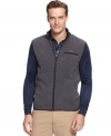 Form and function go sleeveless with this wind-resistant Greg Norman for Tasso Elba big & tall vest.