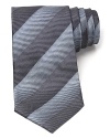Thin tonal stripes dash across this handsome tie, rendered in luxurious Italian silk for classic opulence.