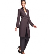 Calvin Klein uses minimal decoration and a belted waist to draw your eye towards the clean lines of this elongated blazer.