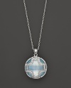 A faceted doublet of Swiss blue topaz and white sapphire, set in sterling silver, forms an elegant Maltese cross. By Elizabeth Showers.