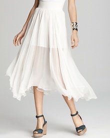 An ethereal, ivory Aqua skirt softens your style, flaunting feminine pleats on an asymmetric silhouette. An ethereal, ivory Aqua skirt softens your style, flaunting feminine pleats on an asymmetric silhouette.