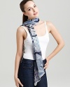 A sheer oblong scarf featuring a gorgeous tropical flora print and signature logo at hem.