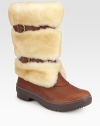 Belt-inspired straps cinch this plush shearling boot with rich leather accents. Shaft, 10¼Leg circumference, 14Shearling and leather upperPull-on style with adjustable leather strapsShearling liningRubber trek solePadded insoleImported