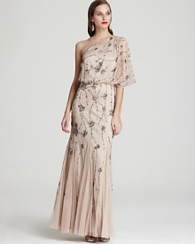 This light-as-air Adrianna Papell one-shoulder gown is splashed with sparkling sequin clusters for an ultra-glam finish. This light-as-air Adrianna Papell one-shoulder gown is splashed with sparkling sequin clusters for an ultra-glam finish.