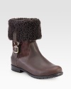 Stay warm wearing this shearling-lined boot made of rich leather and suede with buckled goldtone hardware. Rubber heel, 1 (25mm)Shaft, 11Leg circumference, 13Leather, suede and shearling upperPull-on style with leather adjustable buckle strapShearling liningRubber trek solePadded insoleImported