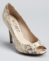 In genuine snakeskin, these KORS Michael Kors pumps exude modern luxury.
