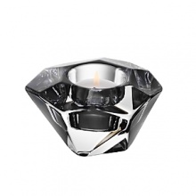 Shimmering facets and an asymmetrical design give this hand-cut, glistening crystal votive a shimmering, jewel-like look. Shimmering facets and an asymmetrical design give this hand-cut, glistening crystal votive a shimmering, jewel-like look.