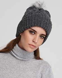 Exude cozy cool in this cable knit beanie topped with the all-essential pom pom from Eugenia Kim. Metallic thread lends modern, on-trend shine.