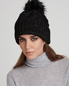 Exude cozy cool in this cable knit beanie topped with the all-essential pom pom from Eugenia Kim. Metallic thread lends modern, on-trend shine. Exude cozy cool in this cable knit beanie topped with the all-essential pom pom from Eugenia Kim. Metallic thread lends modern, on-trend shine.