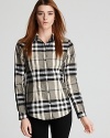 Burberry's classic check print is showcased on a tailored button down shirt from the brand of British cool.