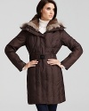 A plush fur collar helps keep out the cold with a glamorous feel in Andrew Marc's flattering belted coat.