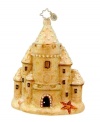 Holiday at the beach. Handcrafted in pure glass with glitter to create a grainy straight-from-the-shore feel, this sandcastle ornament from Christopher Radko gets you in the spirit in places without snow.