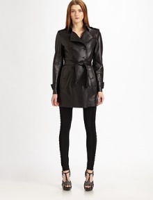 Luxe, supple leather, tailored with classic trench details.Double breasted button frontEpaulettesLong sleeves with belted cuffsSide slash button pocketsSelf beltBack button-down rainflapBack ventAbout 31 from shoulder to hemLambskin leatherDry cleanMade in Italy of imported fabric