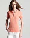 In vibrant orange, this Burberry polo puts a casual spin on lazy weekend afternoons.