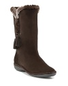 Luxe suede boots lined in soft faux fur feature playful tassels for a preppy punch. By Stuart Weitzman.