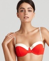 Flirty and feminine. Nanette Lepore's vintage-inspired bikini top is a must for the cabana coquette. The red and white style partners with the matching briefs to make a sultry splash.