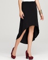 A striking elongated back hem creates drama on this ALTERNATIVE skirt.