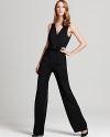 Fluid lines and a draped V neckline lend streamlined sophistication to this Anne Klein Collection jumpsuit, the perfect way to make a stylish statement at cocktail hour.