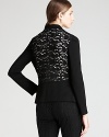 A careerist essential, the black DKNYC blazer, gets contemporary edge as a lace back elevates the classic silhouette.