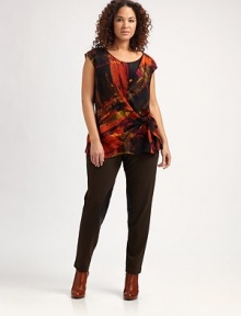 Featuring a bold, abstract look, a silk top with a flattering side tie and gathered details.Round neckCap sleevesAllover printSide tie at draped waistAbout 27 from shoulder to hemSilkDry cleanImported