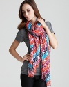 A playful logo and vibrant colors decorate this long soft scarf from MARC BY MARC JACOBS.