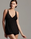 An elegant camisole and shorts set with sheer floral lace accents along straps, back and hemline.