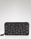 Touting edgy grommets and cutouts, Anya Hindmarch's leather wallet is far from basic. Slipped out from an it bag, it will make an instant statement.