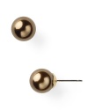 Carolee's pearl studs in a neutral hue are a simple yet striking choice whether worn with sleek suiting or more casually with jeans and a tee.