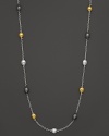 Tricolor, almond-shaped stations in gold and sterling silver shine on this modern necklace from Gurhan.