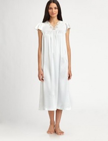 Fluttering cap sleeves lend a touch of romance to this beautiful silhouette, with front shirring and an embroidered neckline. V-neck with embroidered trimShort cap sleevesGathered yokeFront shirringAbout 48 from shoulder to hemPolyesterMachine washImported Fluttering cap sleeves lend a touch of romance to this beautiful silhouette, with front shirring and an embroidered neckline. V-neck with embroidered trimShort cap sleevesGathered yokeFront shirringAbout 48 from shoulder to hemPolyesterMachine washImported