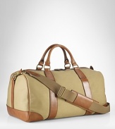 Invoking the classic feel of gentlemen's vintage sporting holdalls, an essential gym bag is crafted from sturdy canvas with rich leather trim and an embossed signature luggage tag for timeless style.
