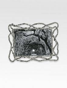 The asymmetric twists and turns of natural vines are recreated by one of America's premier metalwork artists in hand-sculpted, nickel-plated metal. From the Wisteria CollectionWipe cleanImported DIMENSION INFORMATION4 X 6 (6¾ X 8½ overall)5 X 7 (7½ X 9½ overall) The asymmetric twists and turns of natural vines are recreated by one of America's premier metalwork artists in hand-sculpted, nickel-plated metal. From the Wisteria CollectionWipe cleanImported DIMENSION INFORMATION4 X 6 (6¾ X 8½ overall)5 X 7 (7½ X 9½ overall)