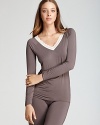 Raglan sleeves and a lace-trimmed neckline lend sophistication to this Calvin Klein pajama top.