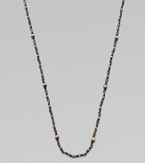 A simply chic design with 14k gold beads on oxidized sterling silver coil links. 14k gold beadsOxidized sterling silverLength, about 28Spring ring closureMade in USA 