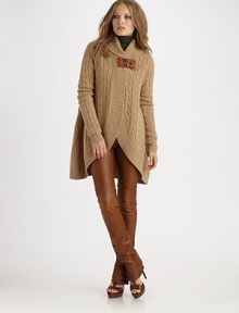 A warm wool piece with beautiful cable and a stylized leather buckle closure. Shawl neck Long sleeves with ribbed cuffs Dual leather buckle closure Tulip hem 80% merino wool/20% cashmere Dry clean Imported of Italian fabrics A warm wool piece with beautiful cable and a stylized leather buckle closure. Shawl neck Long sleeves with ribbed cuffs Dual leather buckle closure Tulip hem 80% merino wool/20% cashmere Dry clean Imported of Italian fabrics