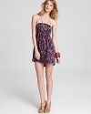 Magenta and purple flowers bloom on a black background on this summer-perfect Hurley strapless dress.