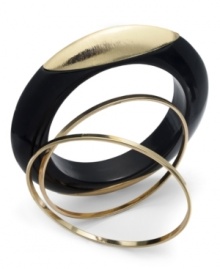 Bold with a splash of shimmer. Bar III's unique three bangle set combines a black resin bangle with a pop of gold detail with two skinny bangles in gold tone mixed metal. Approximate diameter: 2-1/2 inches.