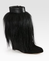 Luxe goat hair covers this suede silhouette topped with leather trim for a look dripping with edgy style. Self-covered wedge, 4¼ (110mm)Goat hair and suede upper with leather trimSide zipLeather lining and solePadded insoleMade in Italy