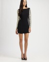 Cutout back and glitzy sequin sleeves give this sultry dress a party-perfect vibe. BoatneckDropped shouldersLong sequin sleevesScoopback; Back cutoutAbout 15 from natural waistRayonDry cleanImportedModel shown is 5'11 (180cm) wearing US size Small.