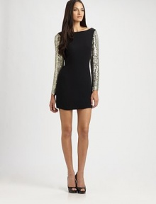 Cutout back and glitzy sequin sleeves give this sultry dress a party-perfect vibe. BoatneckDropped shouldersLong sequin sleevesScoopback; Back cutoutAbout 15 from natural waistRayonDry cleanImportedModel shown is 5'11 (180cm) wearing US size Small.